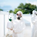 Disinfection specialist team in PPE suit performing public decon