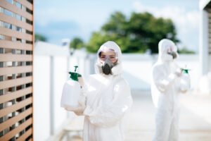 Disinfection specialist team in PPE suit performing public decon