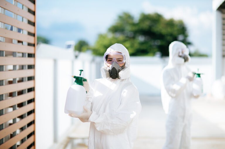 Disinfection specialist team in PPE suit performing public decon